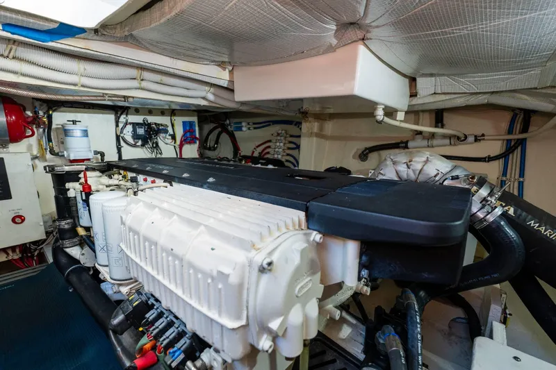 Down Time Yacht Photos Pics Engine room of 2015 Tiara Yachts C44 Coupe, showcasing mechanical components and piping.