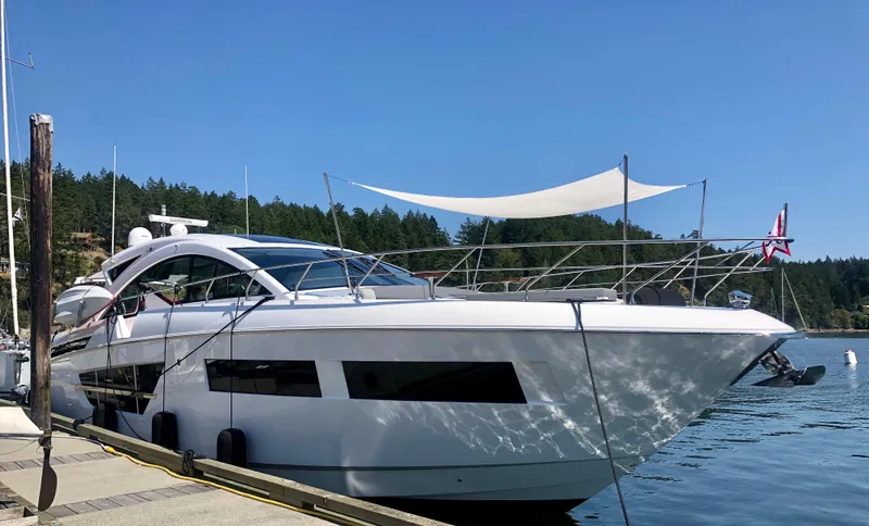  Yacht Photos Pics 2021 Cruisers Yachts 60 Cantius docked in a serene marina setting.
