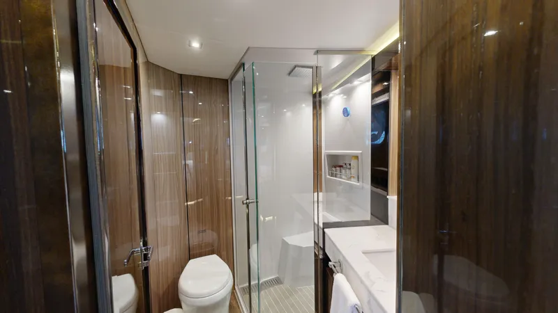  Yacht Photos Pics Luxurious bathroom in 2021 Cruisers Yachts 60 Cantius with glass shower and modern fixtures.