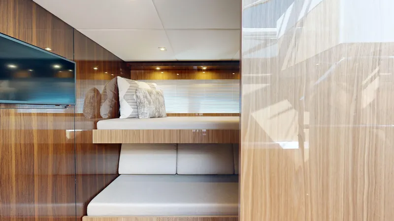  Yacht Photos Pics Luxurious 2021 Cruisers Yachts 60 Cantius interior with modern wood finish and cozy bedding.