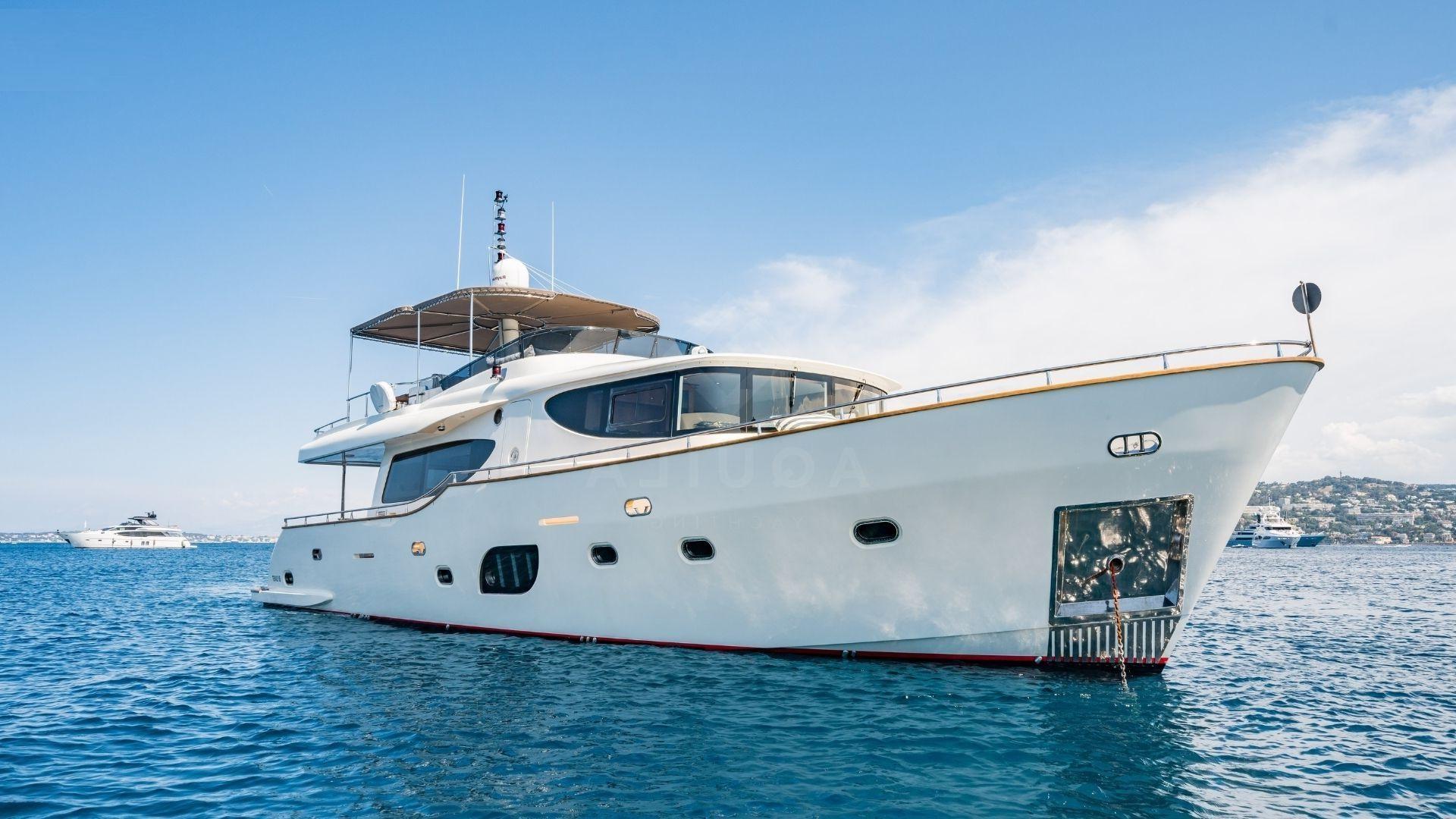 Explorer Trawler 67-70' yacht, 2012 model, cruising on clear blue waters.