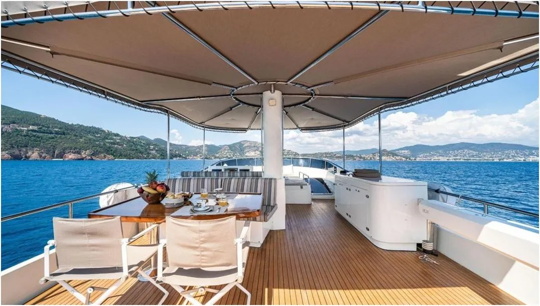 Luxurious Explorer trawler 67-70' yacht deck with dining area, ocean view, and canopy, 2012 model.