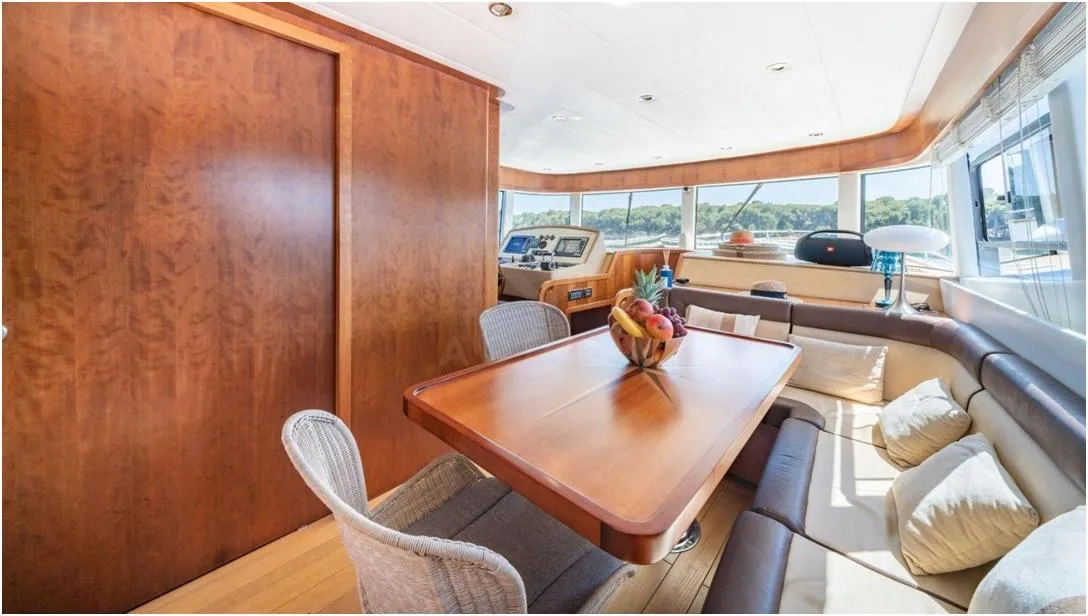 Luxurious interior of 2012 Explorer Trawler 67-70' with elegant dining area and panoramic windows.