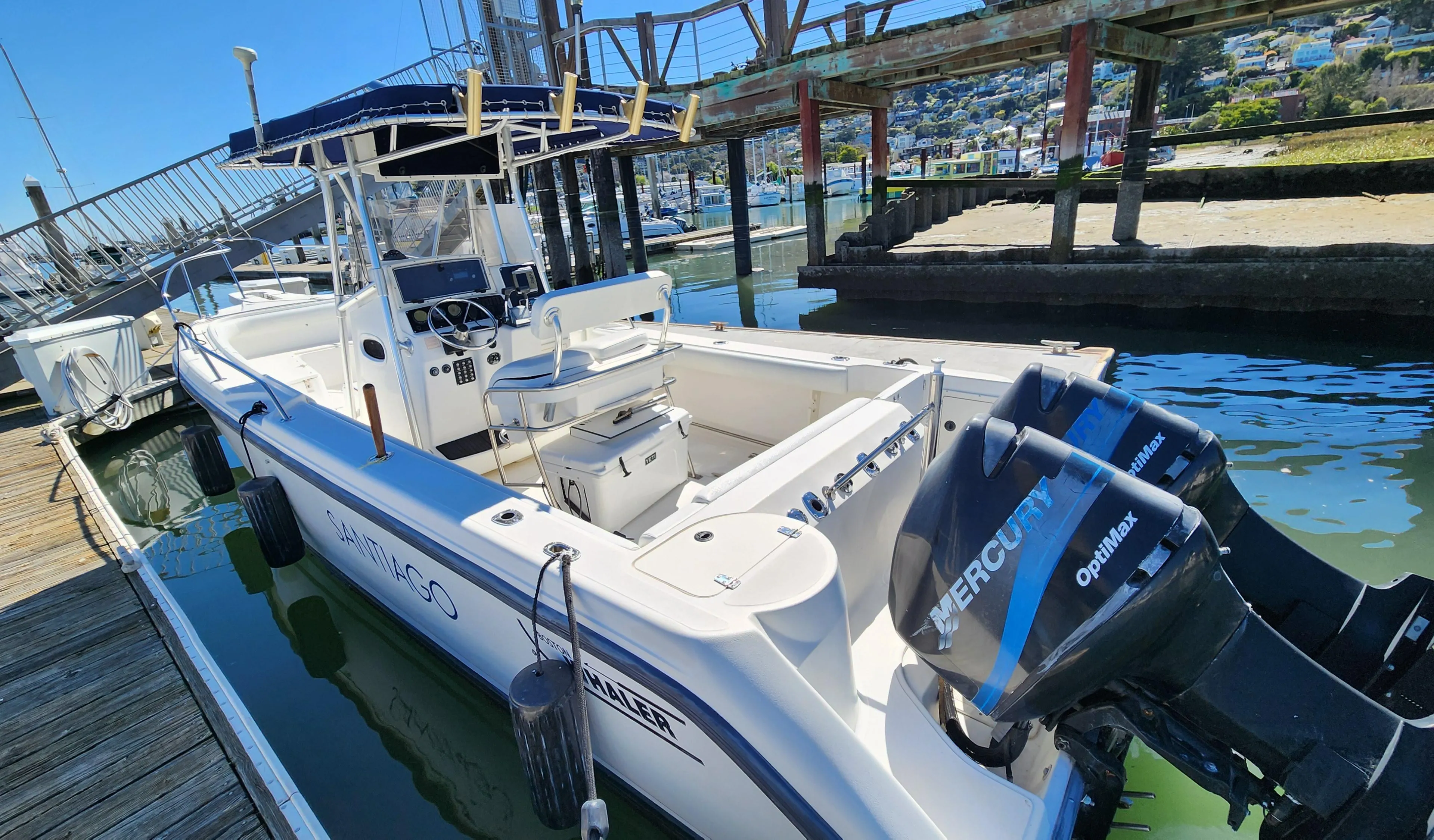 2001 Boston Whaler 26 Outrage boat docked with twin Mercury engines.