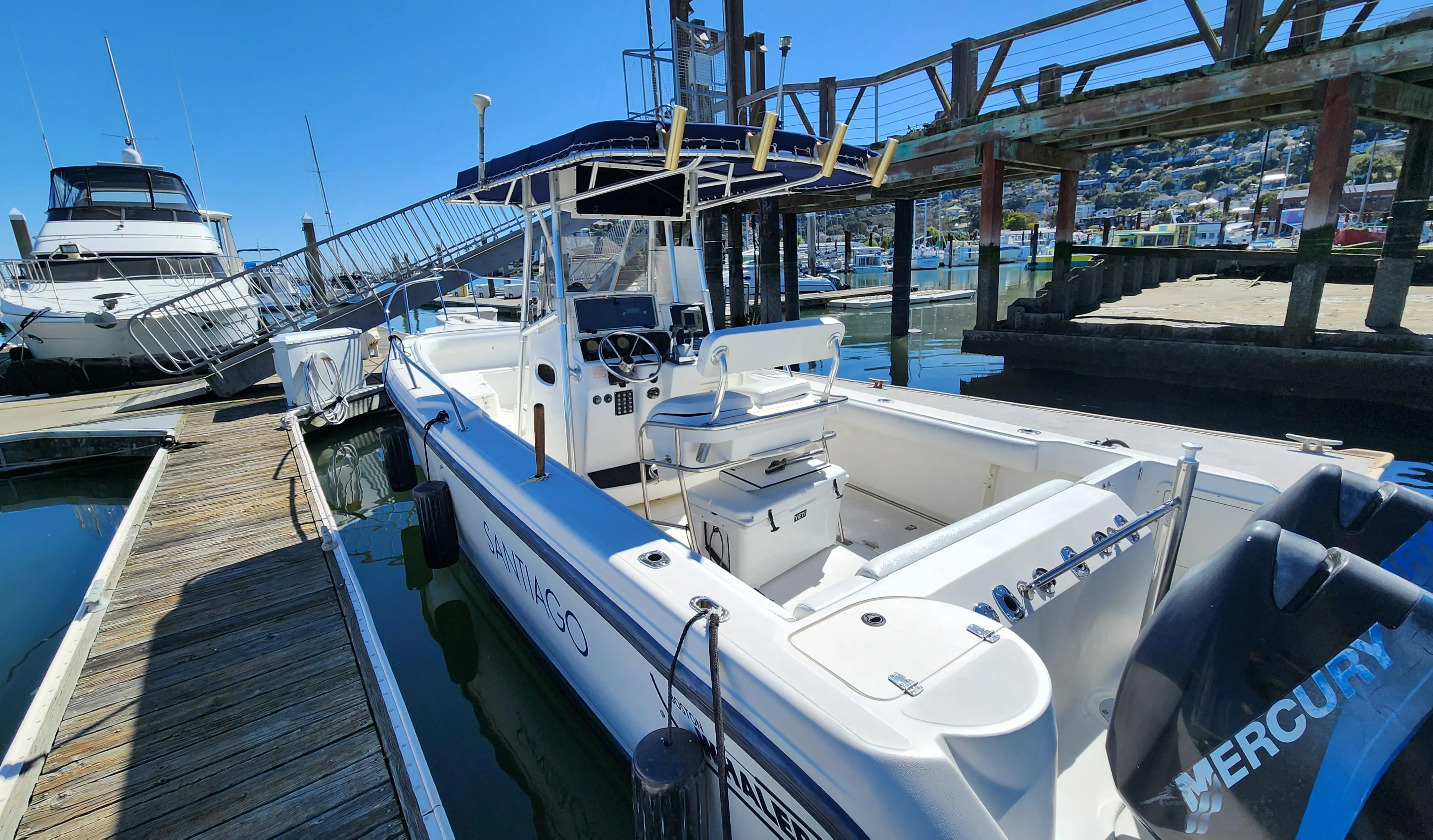 2001 Boston Whaler 26 Outrage docked at marina, featuring spacious deck and Mercury engine.