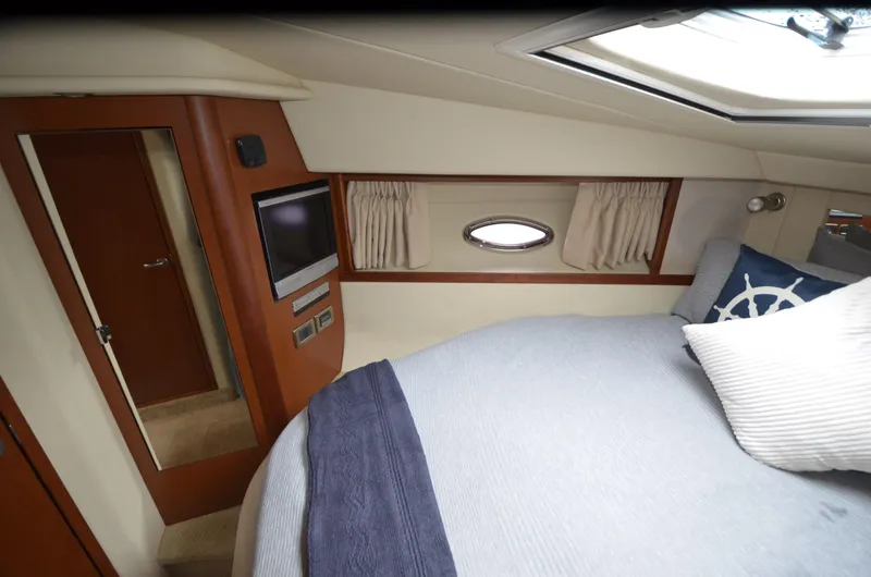  Yacht Photos Pics 2007 Sea Ray 38 Sundancer cabin interior with bed, porthole, and TV.