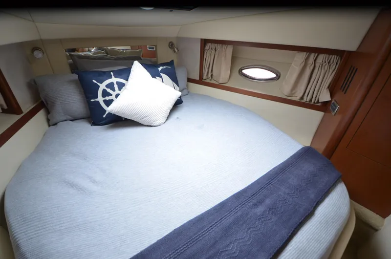  Yacht Photos Pics Cozy cabin interior of 2007 Sea Ray 38 Sundancer with nautical-themed bedding.