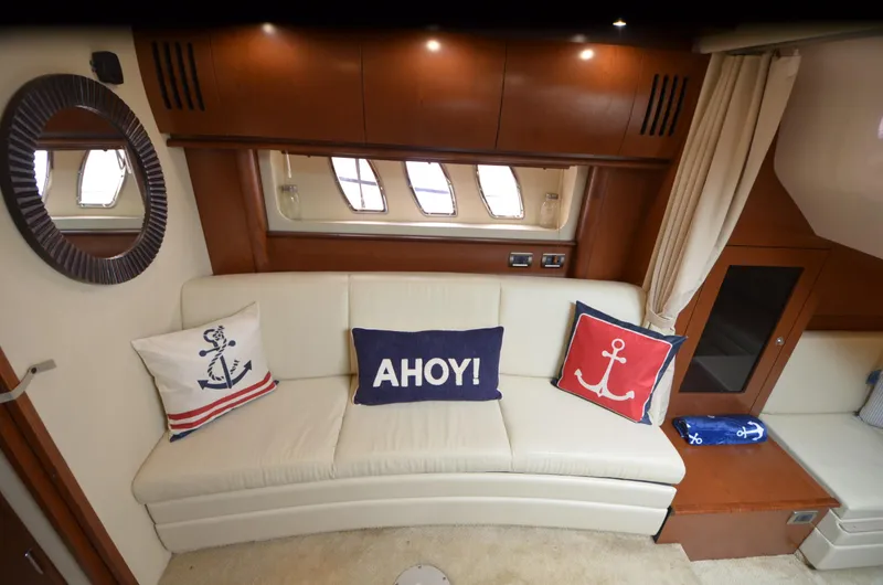  Yacht Photos Pics Interior of 2007 Sea Ray 38 Sundancer with nautical-themed pillows on a white sofa.