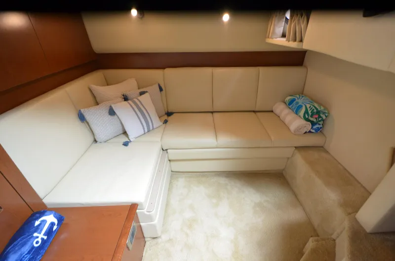  Yacht Photos Pics Luxurious interior of 2007 Sea Ray 38 Sundancer with cream leather seating and nautical decor.
