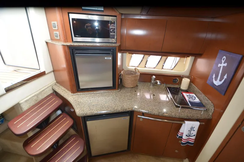  Yacht Photos Pics 2007 Sea Ray 38 Sundancer yacht kitchen with microwave, fridge, and granite countertops.