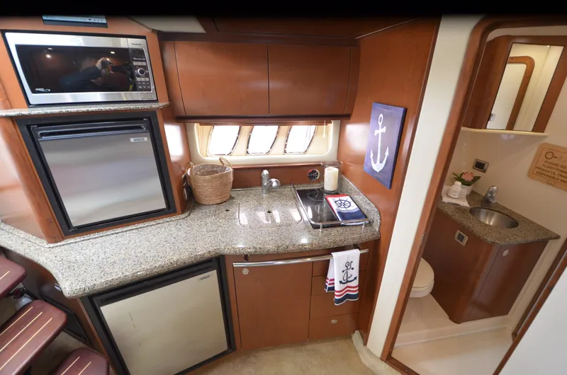  Yacht Photos Pics 2007 Sea Ray 38 Sundancer yacht interior with kitchenette and bathroom.