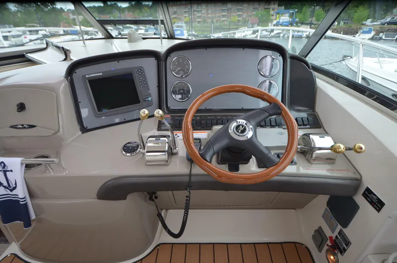  Yacht Photos Pics 2007 Sea Ray 38 Sundancer helm with wooden steering wheel and modern navigation controls.