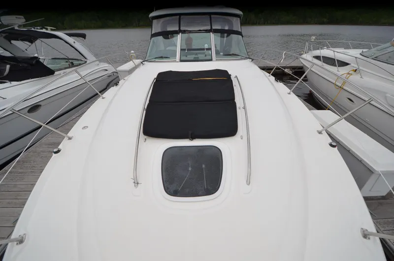  Yacht Photos Pics 2007 Sea Ray 38 Sundancer yacht docked, featuring sleek white deck and black cover.