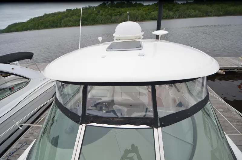  Yacht Photos Pics 2007 Sea Ray 38 Sundancer yacht docked by a serene river with lush greenery.