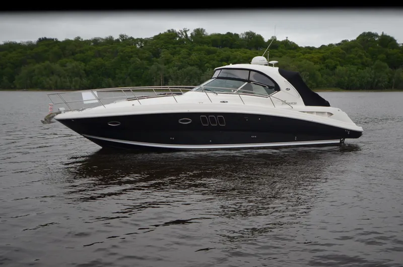  Yacht Photos Pics 2007 Sea Ray 38 Sundancer yacht on calm water with lush green background.