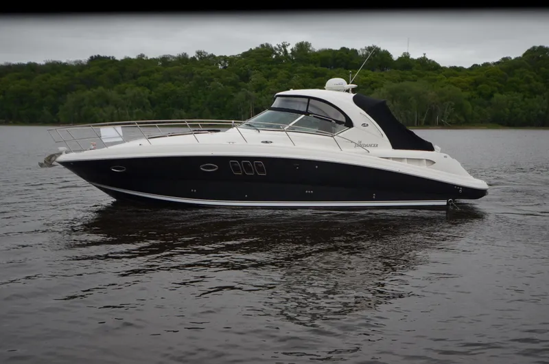  Yacht Photos Pics 2007 Sea Ray 38 Sundancer yacht on calm water with lush green background.