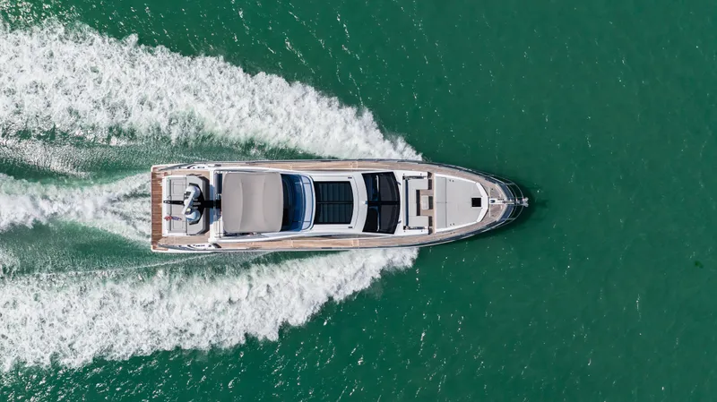 Swaha Yacht Photos Pics Aerial view of 2018 Azimut S7 yacht cruising on turquoise water.