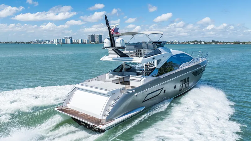 Swaha Yacht Photos Pics Luxury 2018 Azimut S7 yacht cruising on open water under a clear blue sky.