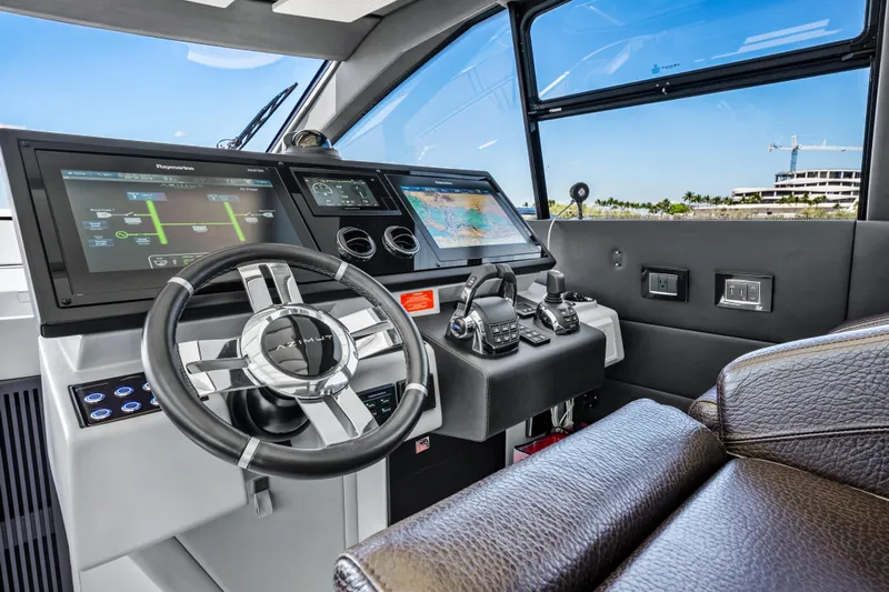 Swaha Yacht Photos Pics Cockpit of 2018 Azimut S7 yacht with modern navigation controls and leather seating.