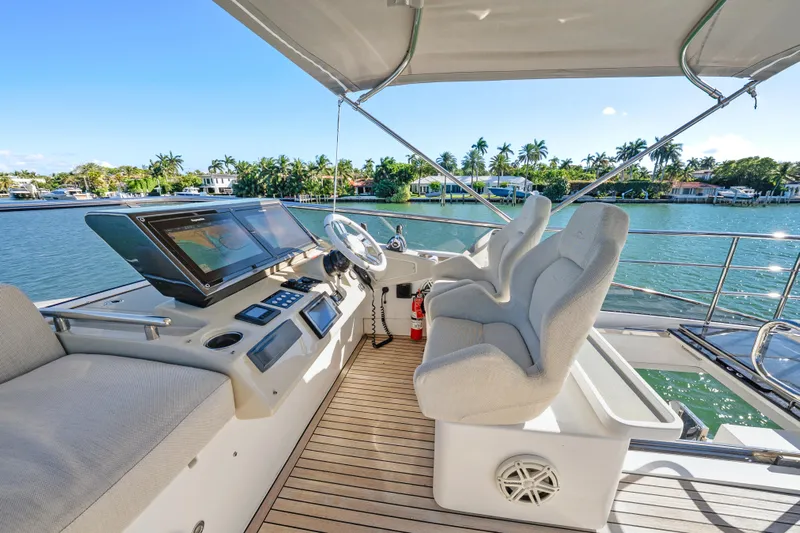 Swaha Yacht Photos Pics Helm of 2018 Azimut S7 yacht with modern controls and waterfront view.