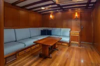 Luxurious wooden interior of 1929 Camper & Nicholsons J Class yacht with elegant seating.