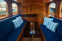 Luxurious 1929 Camper & Nicholsons J Class yacht interior with blue seating and striped pillows.