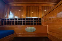 Interior of 1929 Camper & Nicholsons J Class yacht with polished wood and seating.