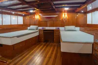 Luxurious 1929 Camper & Nicholsons J Class yacht cabin with wooden interior and twin beds.