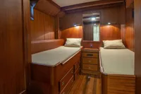 Luxurious wooden cabin interior of 1929 Camper & Nicholsons J Class yacht with twin beds.