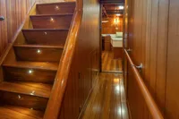 Luxurious wooden interior of 1929 Camper & Nicholsons J Class yacht with staircase and hallway.