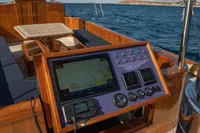 1929 Camper & Nicholsons J Class yacht with navigation panel, wooden deck, and ocean view.