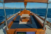 Luxurious 1929 Camper & Nicholsons J Class yacht deck with wooden seating and ocean view.