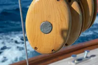 Wooden pulley on 1929 Camper & Nicholsons J Class yacht, sailing on open sea.