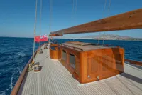 1929 Camper & Nicholsons J Class yacht with wooden deck sailing on open sea.