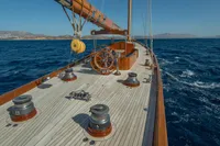 1929 Camper & Nicholsons J Class yacht sailing on open sea, showcasing elegant wooden deck.