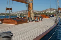 1929 Camper & Nicholsons J Class yacht deck with scenic coastal backdrop.