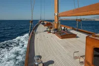 1929 Camper & Nicholsons J Class yacht sailing on open sea, showcasing elegant wooden deck.
