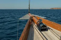 Bow of 1929 Camper & Nicholsons J Class yacht sailing on open sea.