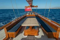 1929 Camper & Nicholsons J Class yacht deck with seating, table, and ocean view.