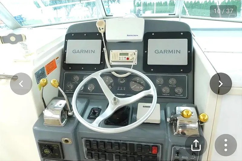  Yacht Photos Pics Helm console of a 1997 Pursuit 3000 Express boat.