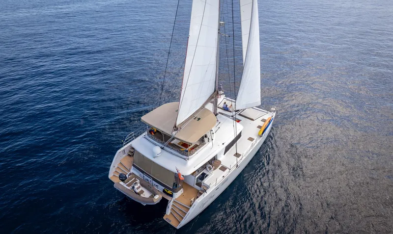 Copper Penny Yacht Photos Pics Lagoon 560 catamaran sailing on open sea, 2011 model, aerial view.