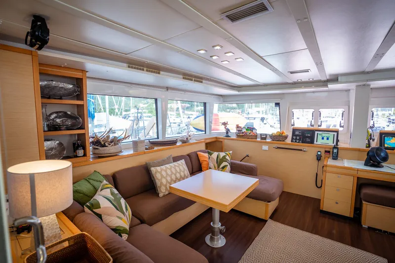 Copper Penny Yacht Photos Pics Luxurious interior of a 2011 Lagoon 560 yacht with modern furnishings and large windows.