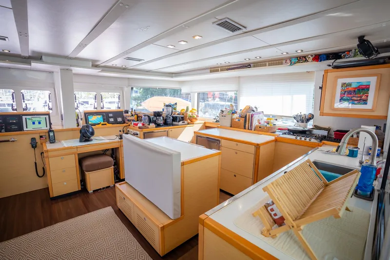Copper Penny Yacht Photos Pics Luxurious interior of 2011 Lagoon 560 yacht with modern kitchen and navigation area.