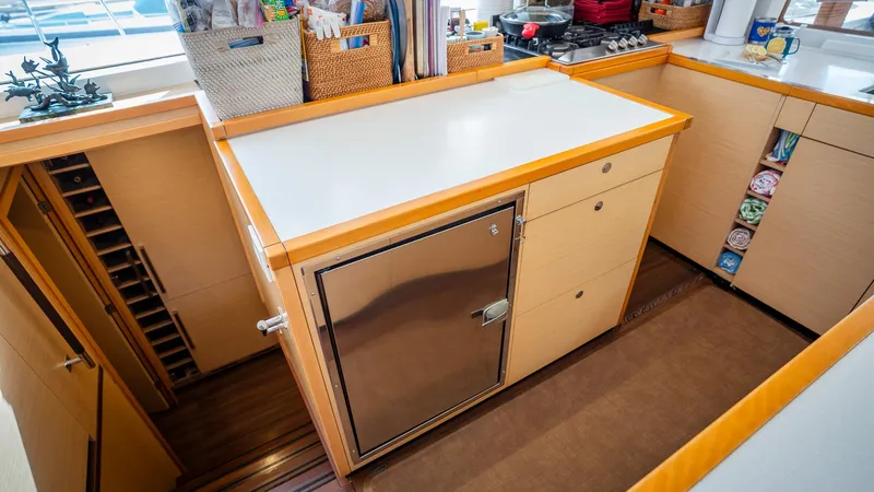 Copper Penny Yacht Photos Pics Modern kitchen area in a 2011 Lagoon 560 yacht with ample storage and sleek design.