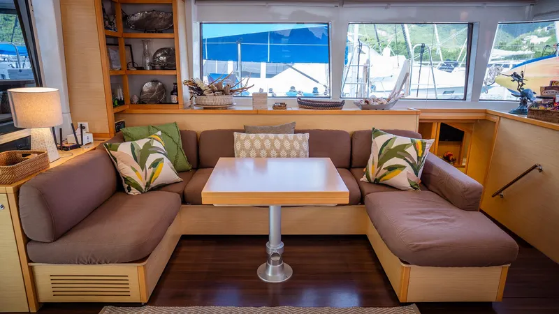 Copper Penny Yacht Photos Pics Luxurious Lagoon 560 yacht interior with cozy seating and decorative pillows, 2011 model.