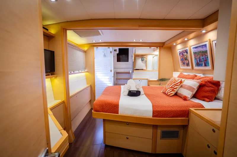 Copper Penny Yacht Photos Pics Luxurious cabin interior of 2011 Lagoon 560 yacht with cozy bed and modern decor.