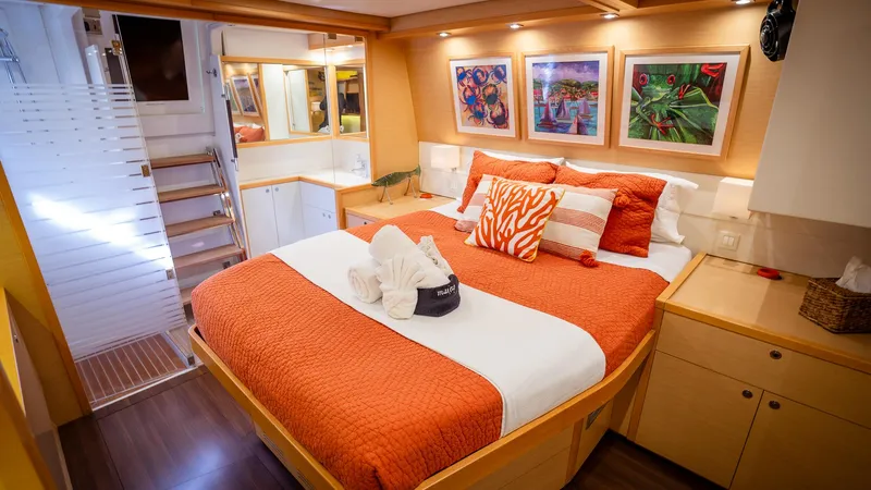 Copper Penny Yacht Photos Pics Luxurious bedroom interior of 2011 Lagoon 560 yacht with vibrant orange decor.