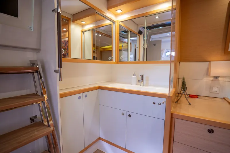 Copper Penny Yacht Photos Pics Interior of 2011 Lagoon 560 yacht featuring a modern bathroom with mirrors and wooden accents.