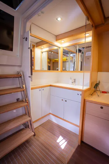 Copper Penny Yacht Photos Pics Luxurious interior of 2011 Lagoon 560 yacht with modern cabinetry and wooden accents.