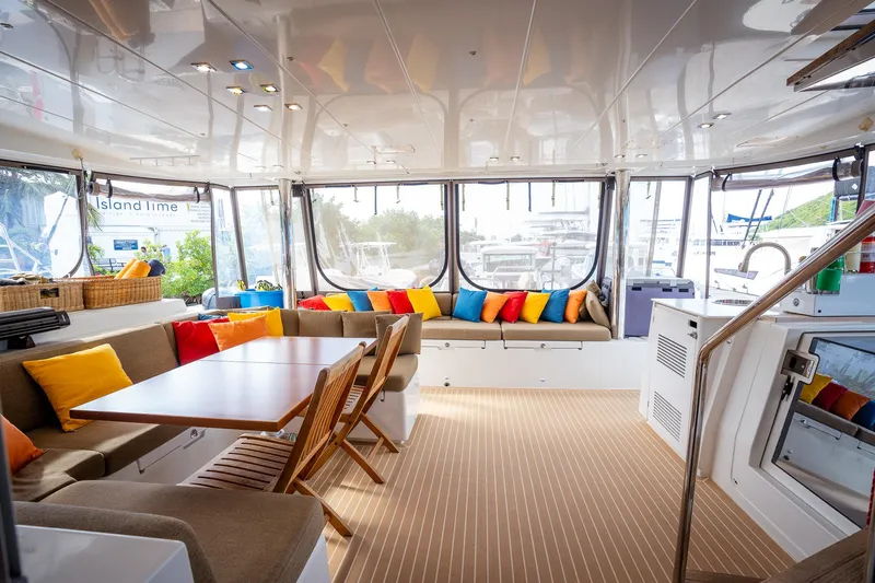 Copper Penny Yacht Photos Pics Luxurious Lagoon 560 yacht interior, 2011 model, featuring colorful cushions and elegant seating.